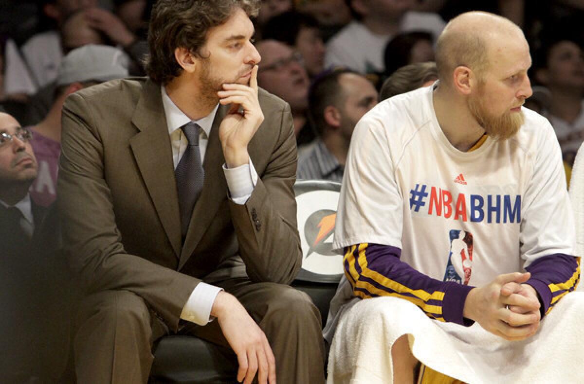Lakers 7-footer Pau Gasol sits alongside teammate Chris Kaman as he bides his time to recover from a groin injury.