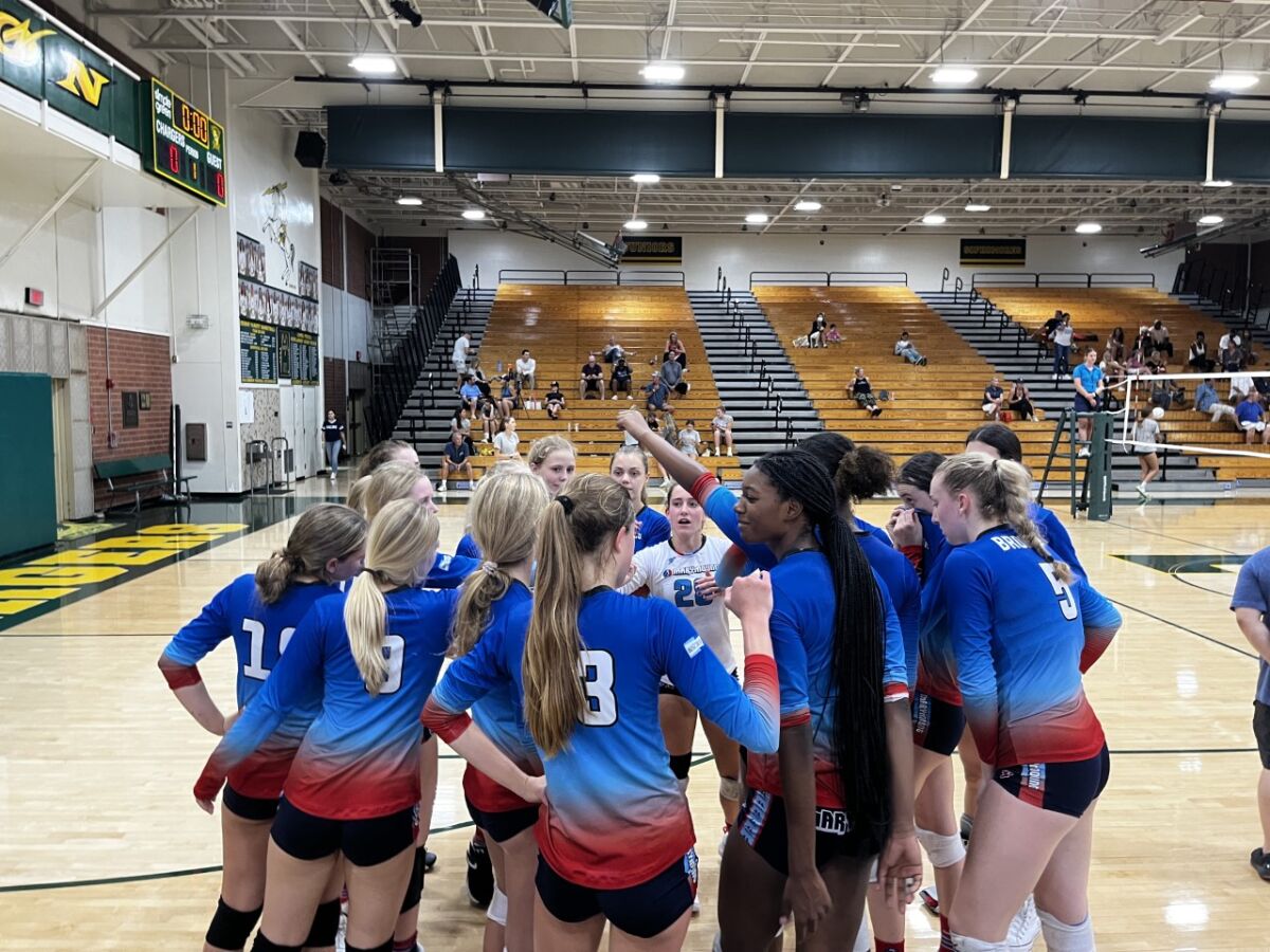 Marymount girls' volleyball players huddle