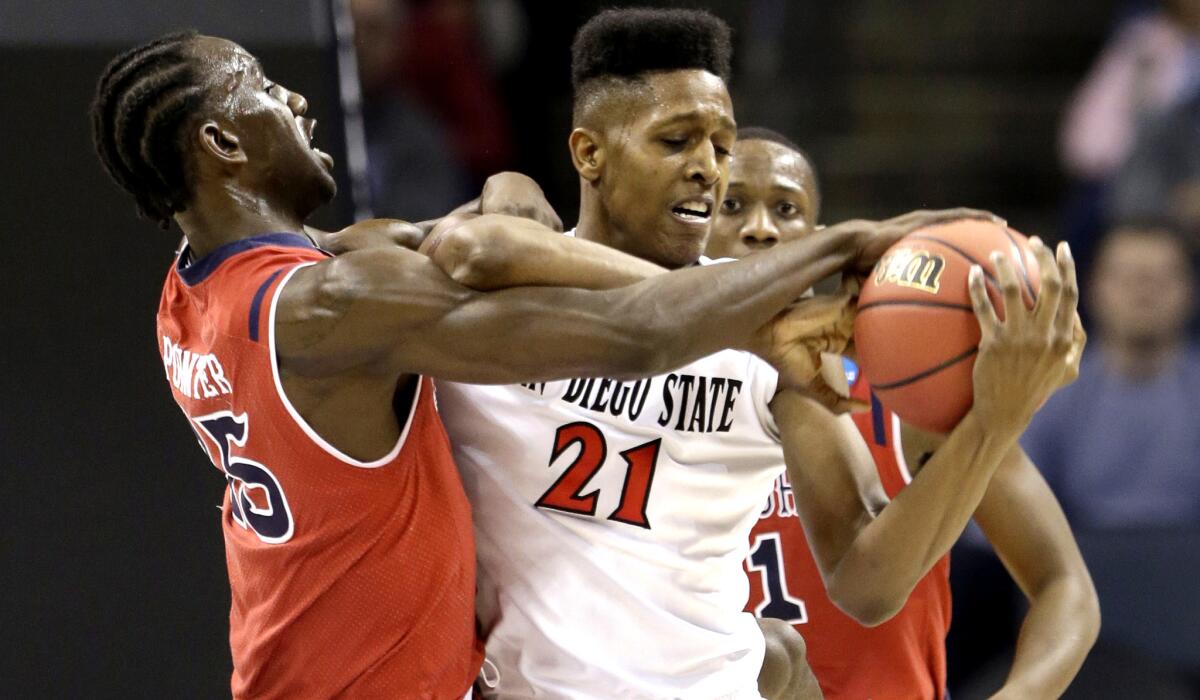 St. John's Sir'Dominic Pointer (15) and San Diego State's Malik Pope (21) battle for a rebound in the first half of the Aztecs' 76-64 victory on Friday.