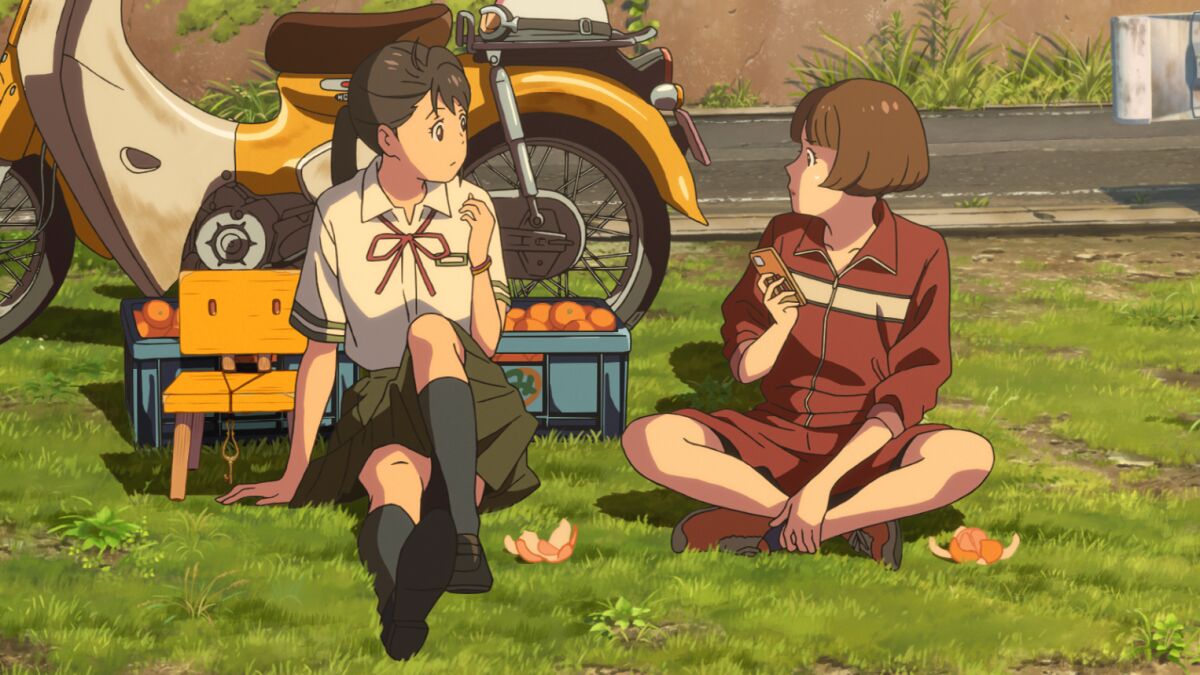 two animated characters sitting on a patch of grass eating tangerines