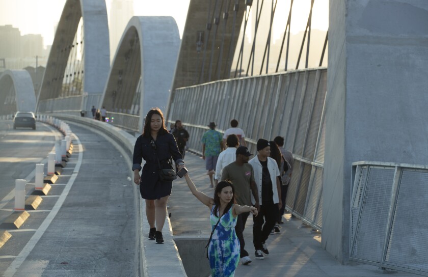 Pedestrians cross the new 6th Street Bridge.