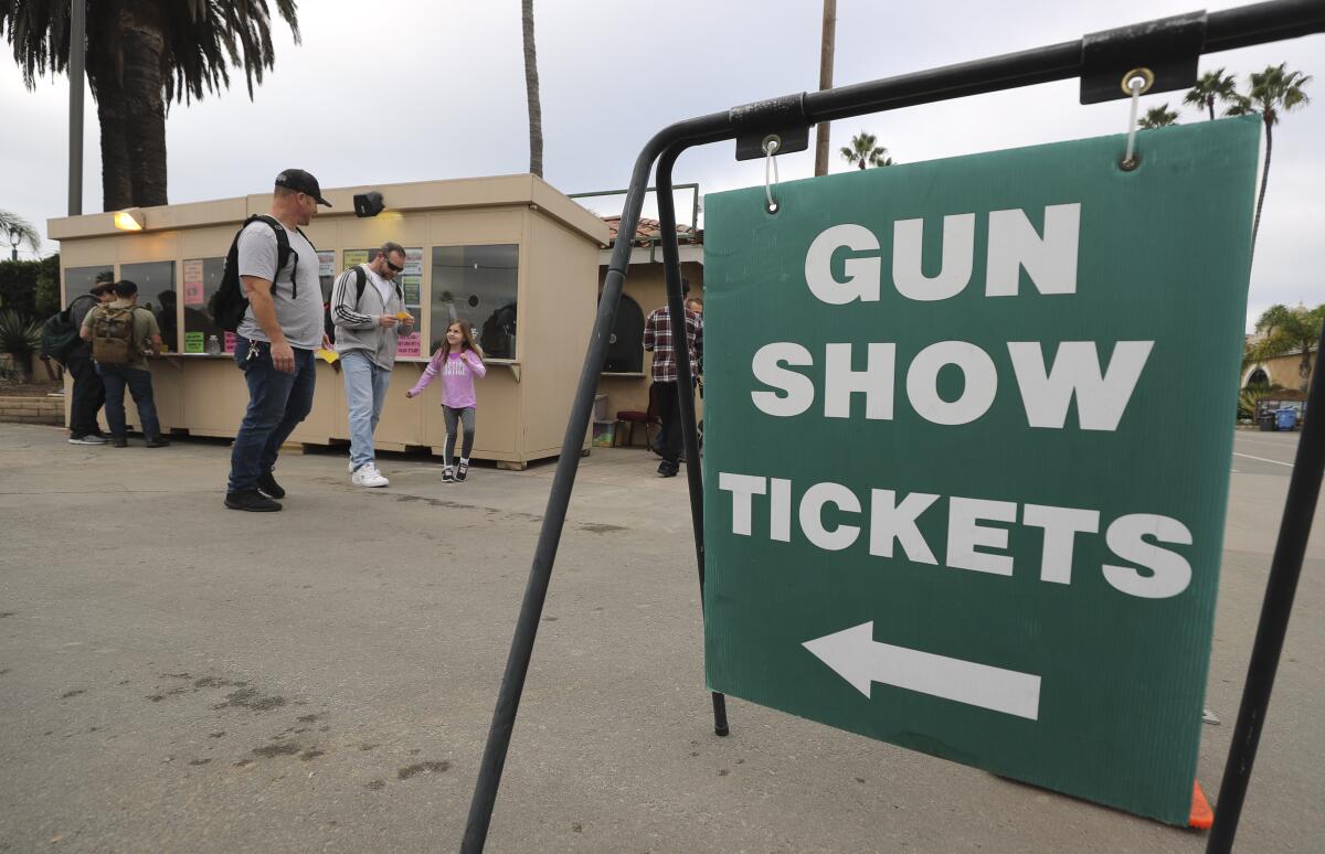 People buy tickets to the Crossroads of the West Gun Show at the Del Mar Fairgrounds 