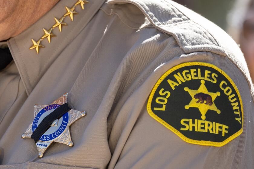 PALMDALE, CA - SEPTEMBER 18: Los Angeles County Sheriff Robert Luna wears a black band over his badge in memory of Dep. Ryan Clinkunbroomer who was shot to death Saturday evening. The Sheriff announced the arrest of a suspect Monday morning Sept. 18, 2023. (Myung J. Chun / Los Angeles Times)