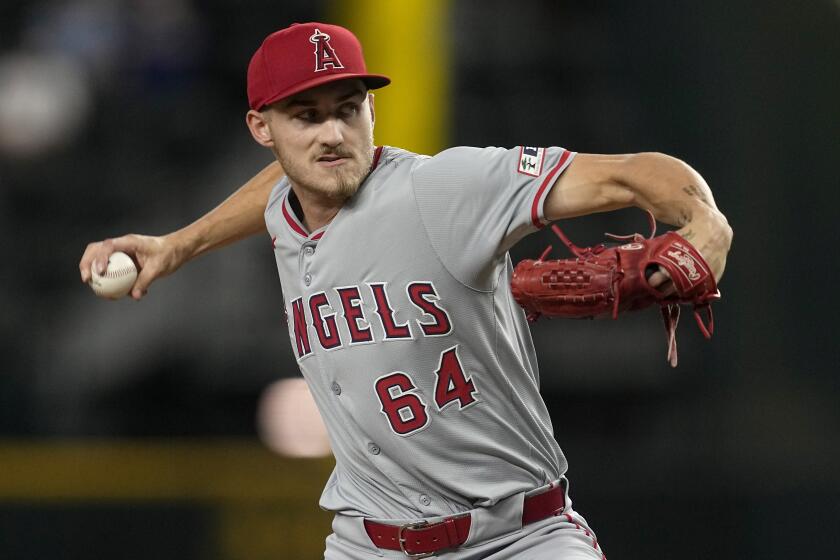 Los Angeles Angels starting pitcher Jack Kochanowicz throws to the Texas Rangers.