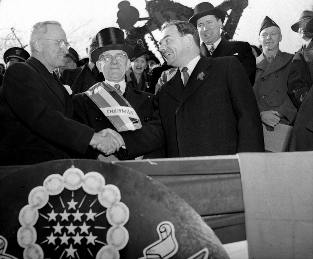 President Truman, left, shakes hands with Gov. Thomas E. Dewey.