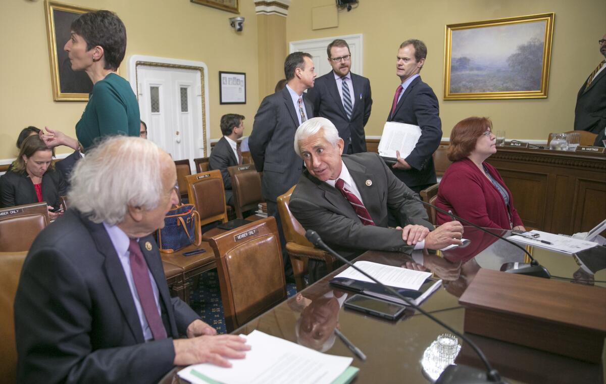 House Ways and Means Committee member Rep. Dave Reichert (R-Wash.), center, confers Thursday with Rep. Sander Levin of Michigan, the committee's ranking Democrat, as Congress worked on legislation to avert a government shutdown.