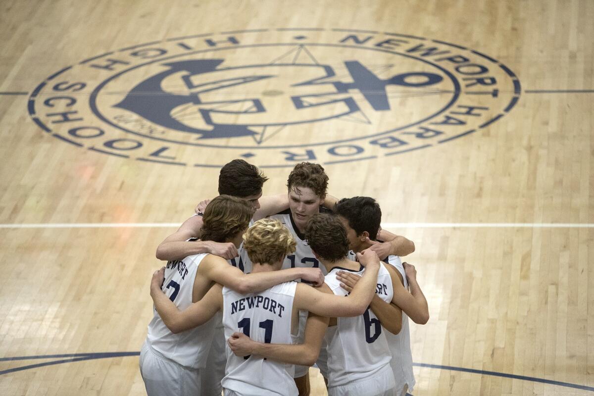 Newport Harbor's team huddles before Game 5 of the CIF State Southern California Regional Division I semifinal playoff match against Los Angeles Loyola in Newport Beach on Thursday.