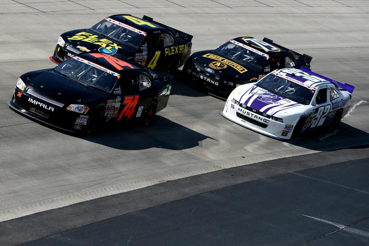 Mike Harmon, driver of the #74 Dave Novack Racing Chevrolet, leads Landon Cassill, driver of the #4 Flex Seal Chevrolet, Jeffrey Earnhardt, driver of the #79 Oath Keepers Ford, and Dexter Stacey, driver of the #92 Maddie's Place Ford, during the NASCAR Nationwide Series 5-hour ENERGY 200 at Dover International Speedway on June 1, 2013 in Dover, Del.