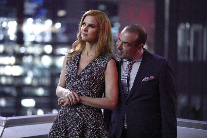 Suits -- USA TV Series, SUITS -- "100" Episode 708 -- Pictured: (l-r) Sarah Rafferty as Donna Paulsen, Rick Hoffman as Louis Litt -- (Photo by: Shane Mahood/USA Network) Sarah Rafferty and Rick Hoffman in "Suits" on USA.