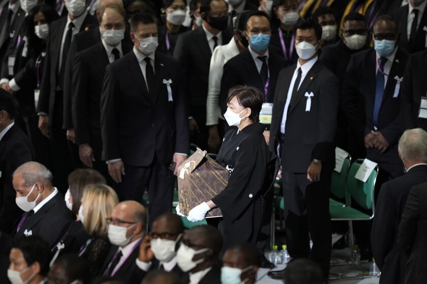 Akie Abe, widow of former Prime Minister of Japan Shinzo Abe, arrives with her husband's remains at the state funeral Tuesday Sept. 27, 2022, at Nippon Budokan in Tokyo. (AP Photo/Eugene Hoshiko, Pool)