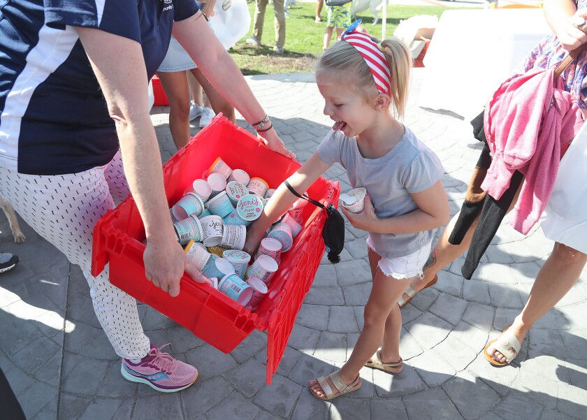 Kaden Faber is the first to grab a few Jeni's ice cream cups to help celebrate the 95th birthday of Laguna Beach.