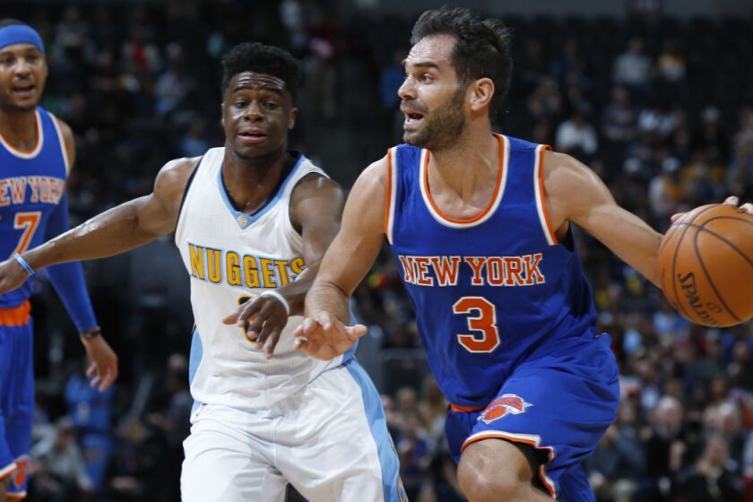 Former New York Knicks guard Jose Calderon, front, drives past Denver Nuggets guard Emmanuel Mudiay during the first half of a game March 8.