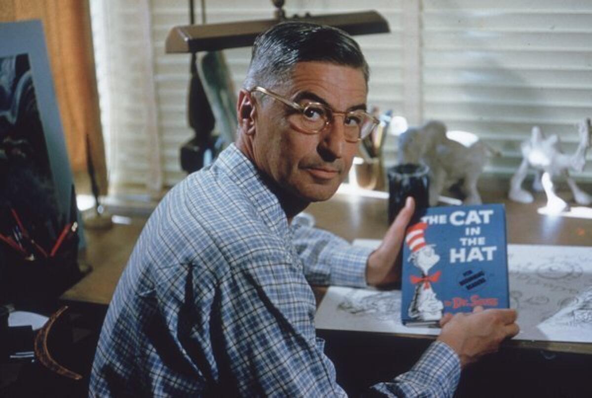 In 1957, author and illustrator Dr Seuss (Theodor Seuss Geisel, 1904-91) sits at the drafting table in his home office in La Jolla, Calif. He holds a bestseller: "The Cat in the Hat."