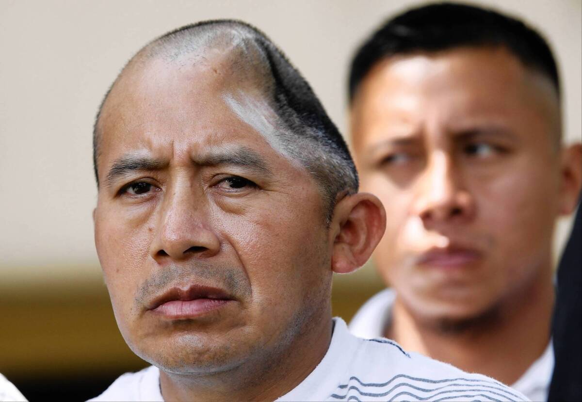 Antonio Lopez Chaj, left, with his brother, Pedro Chang, appears at a news conference on Monday after a jury awarded him $58 million for medical and economic losses. Doctors had to remove a portion of Chaj's skull and brain after he was severely beaten in 2010; he is unable to speak or care for himself.