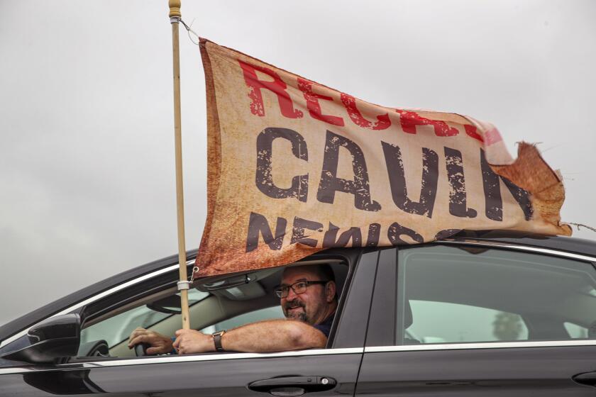 Rowland Heights, CA - August 21: Neil Bromley, from Hanford, joins a rally organized by supporters of recall Gov. Gavin Newsom and Larry Elder at a shopping center parking lot on Saturday, Aug. 21, 2021 in Rowland Heights, CA. (Irfan Khan / Los Angeles Times)