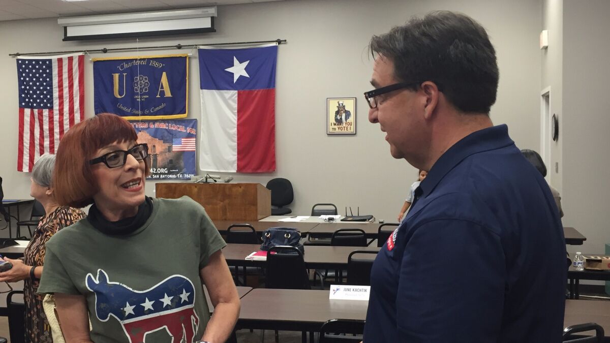 Pete Gallego, right, speaks with a local Democratic official in San Antonio.