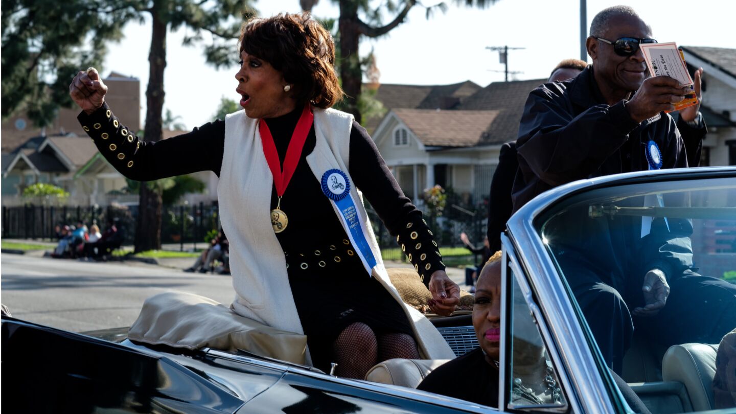 Rep. Maxine Waters (D-Los Angeles) cheers to onlookers at the Kingdom Day Parade.