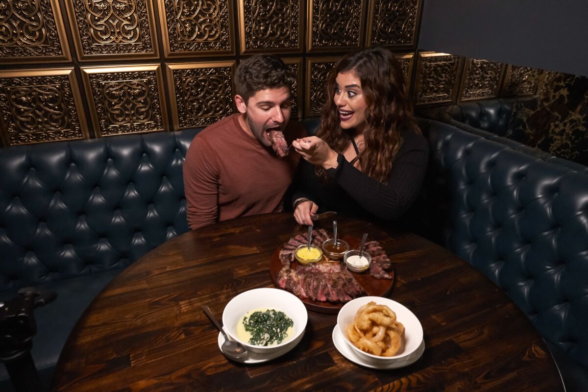 (From left to right) Correy opens up as Jasmine feeds her blind date a large piece of meat at Rare Society in Hillcrest where the two enjoyed a carnivorous dinner.