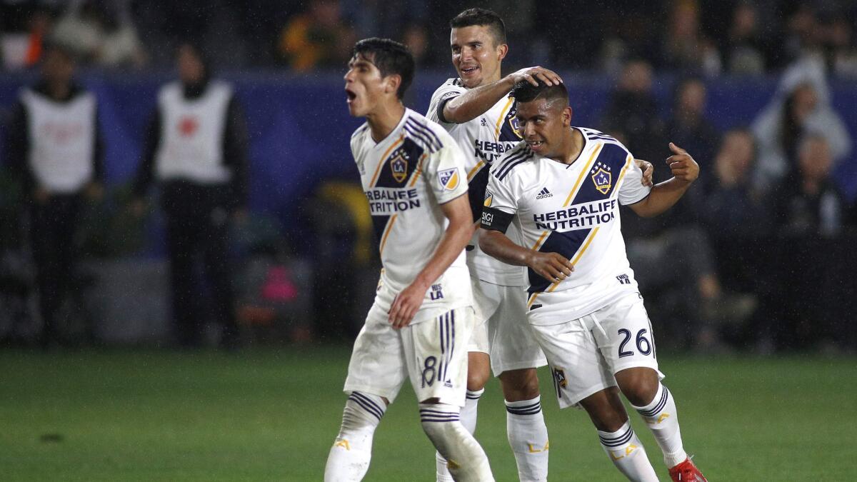 Efrain Alvarez (26) Uriel Antuna (18) and Servando Carrasco (6) of the Galaxy celebrate their first goal against the Chicago Fire at Dignity Health Sports Park.