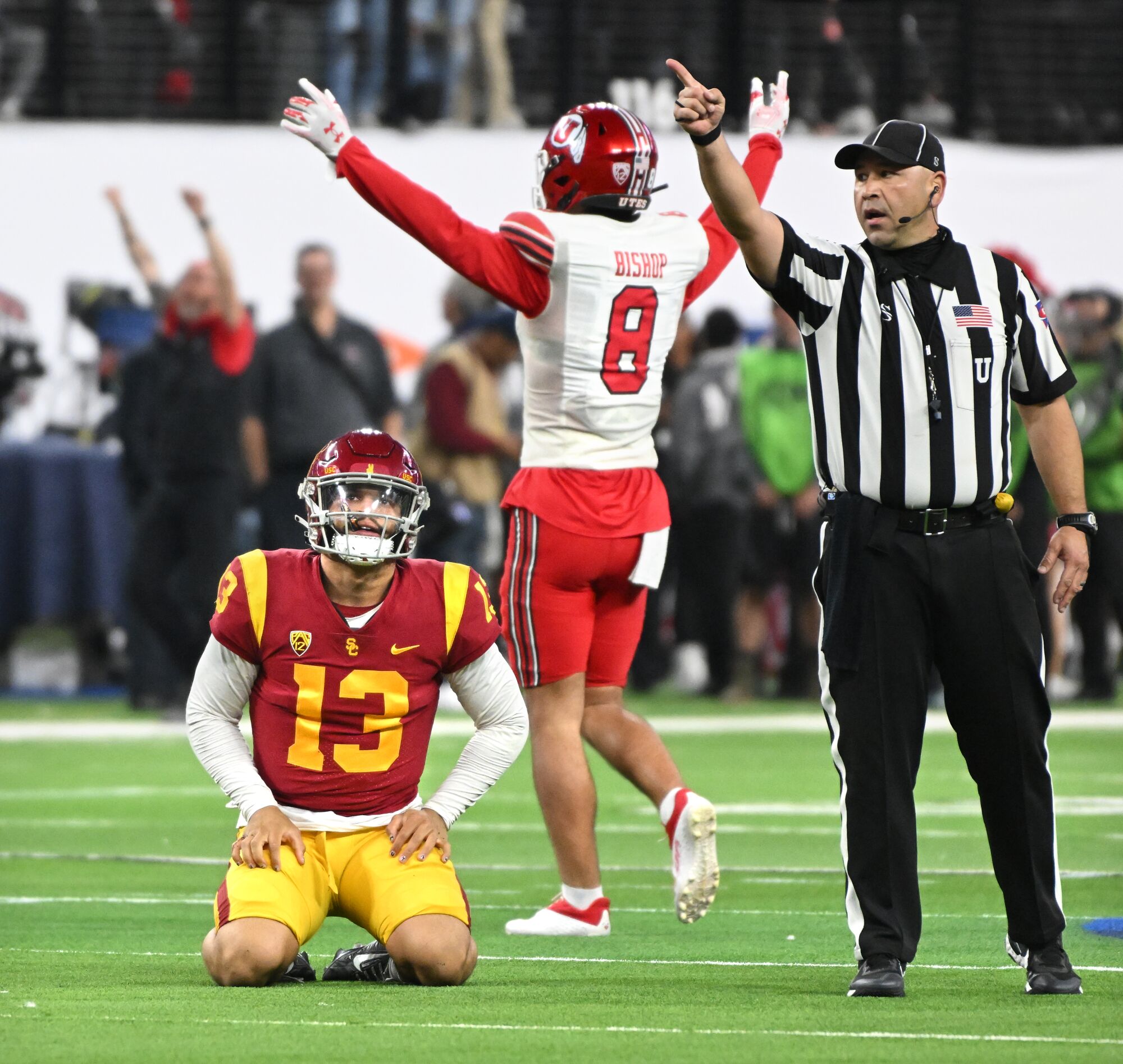 USC quarterback Caleb Williams reacts as Utah safety Cole Bishop celebrates a Utes fumble recovery.