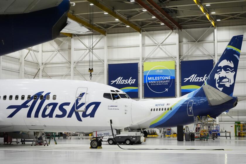 Alaska Airlines aircraft sit in the airline's hangar at Seattle-Tacoma International Airport Wednesday, Jan. 10, 2024, in SeaTac, Wash. Boeing has acknowledged in a letter to Congress that it cannot find records for work done on a door panel that blew out on an Alaska Airlines flight over Oregon two months ago. Ziad Ojakli, Boeing executive vice president and chief government lobbyist, wrote to Sen. Maria Cantwell on Friday, March 8 saying, “We have looked extensively and have not found any such documentation.” (AP Photo/Lindsey Wasson)