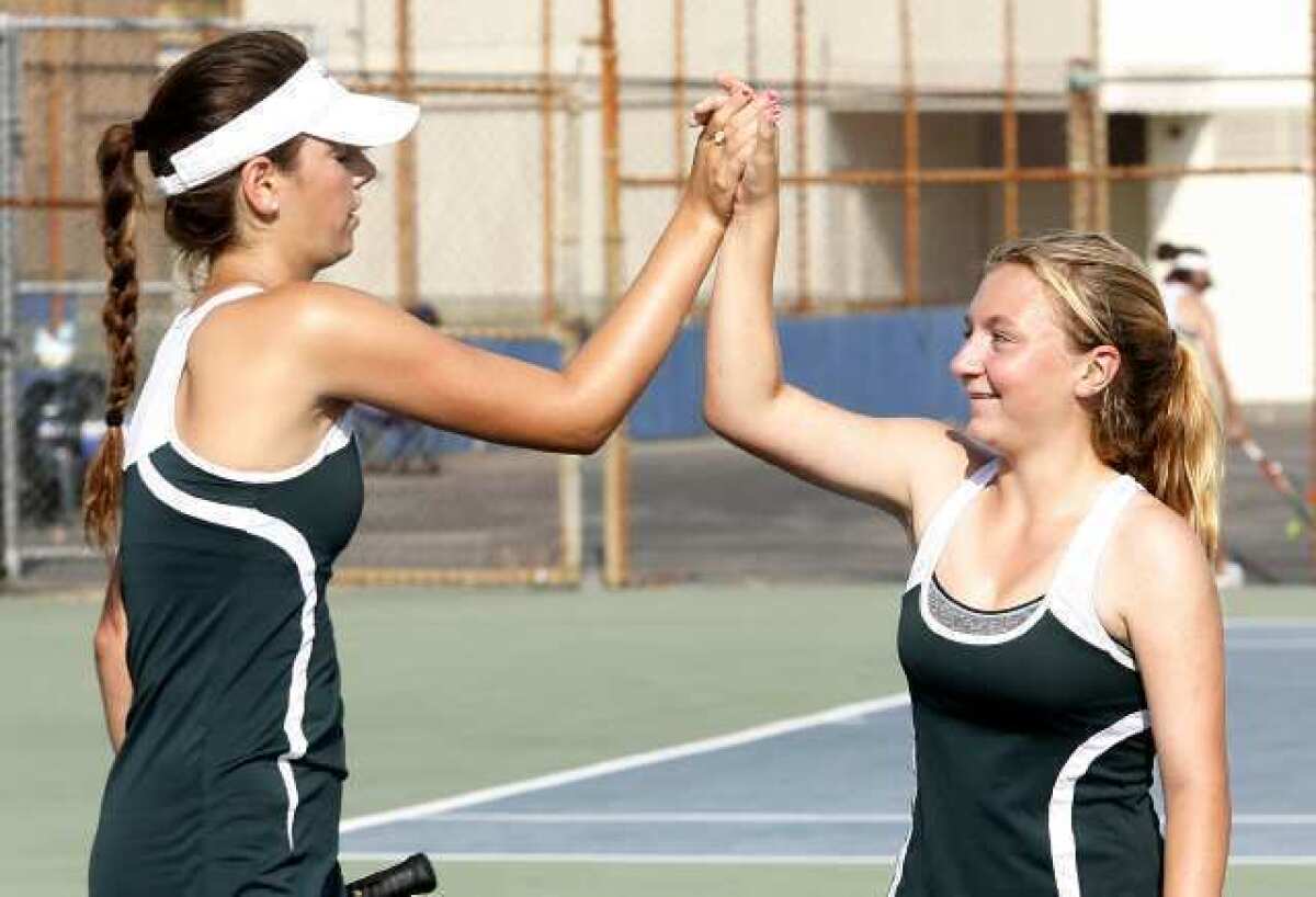 Westridge Tigers' doubles team of Amanda Mathiessen and Cameron Marsh congratulate each other after defeating their opponents from Flintridge Sacred Heart Academy.