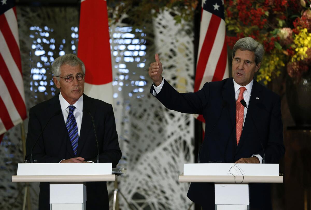 U.S. Defense Secretary Chuck Hagel, left, and Secretary of State John Kerry used their joint news conference in Tokyo on Thursday to reassure Americans and Israelis that the United States is going into nuclear negotiations with Iran "clear-eyed" on the prospects for easing three decades of animosity.