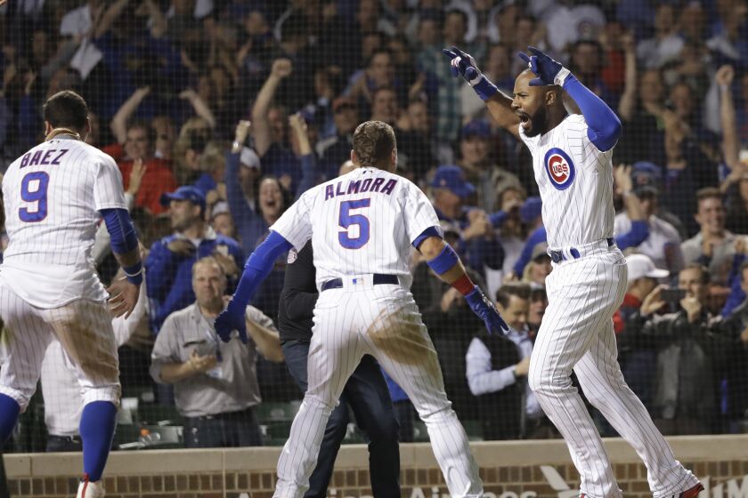 FILE - Chicago Cubs' Jason Heyward, right, celebrates his game-winning grand slam off Philadelphia Phillies relief pitcher Adam Morgan during the ninth inning of a baseball game Wednesday, June 6, 2018, in Chicago. Five-time Gold Glove outfielder Jason Heyward plans to play baseball next season, even if won’t be with the Cubs. Heyward hasn't been in a game since June 24 because of right knee inflammation. Cubs President of Baseball Operations Jed Hoyer said last month that Heyward won't be with Chicago next year. (AP Photo/Charles Rex Arbogast, File)