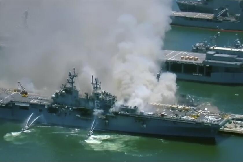 This screenshot provided by KGTV-TV in San Diego shows the USS Bonhomme Richard at Naval Base San Diego Sunday, July 12, 2020, in San Diego after an explosion and fire Sunday on board the ship at Naval Base San Diego. (KGTV-TV via AP)