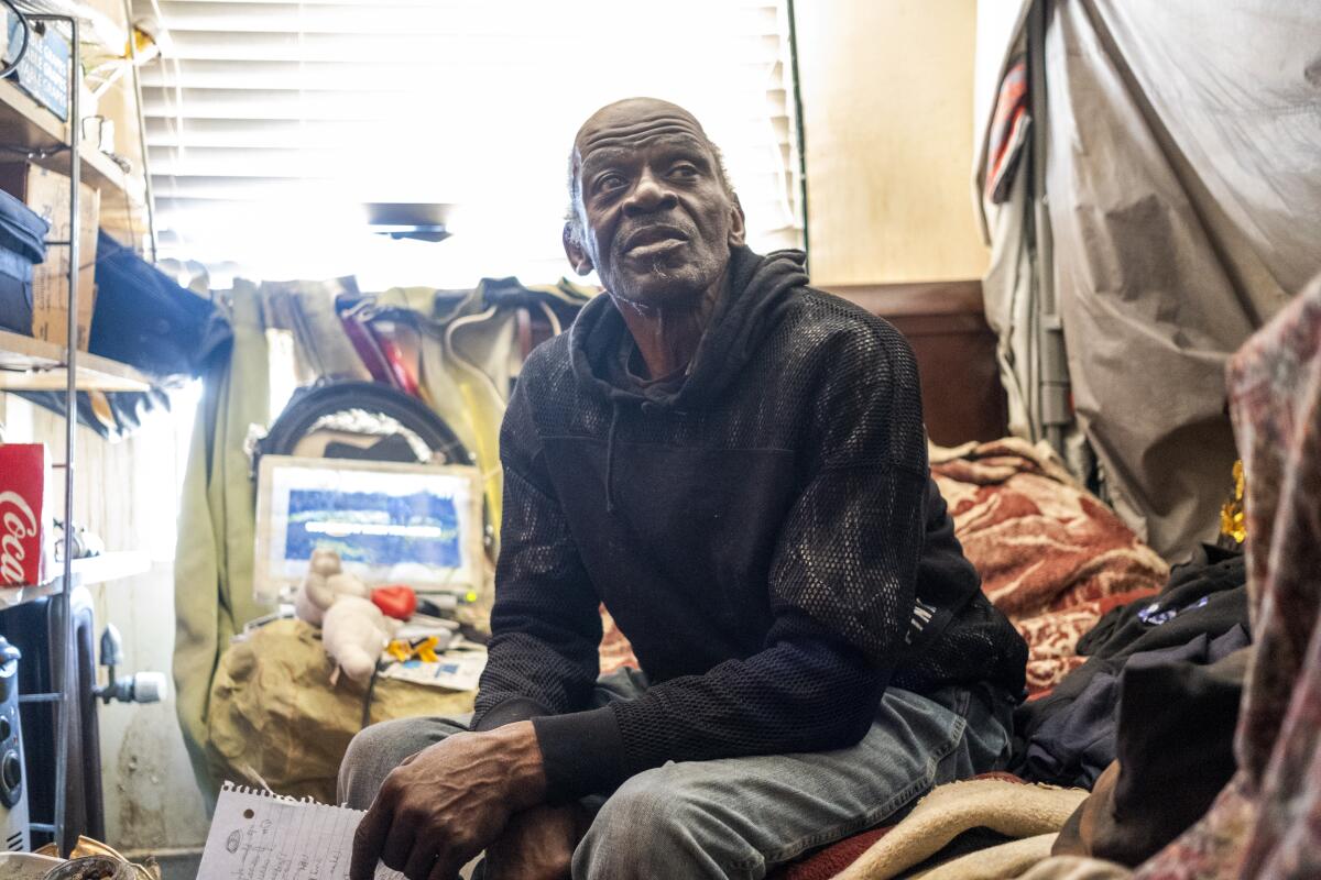 Kenneth Owens sits in his room at the Madison Hotel.