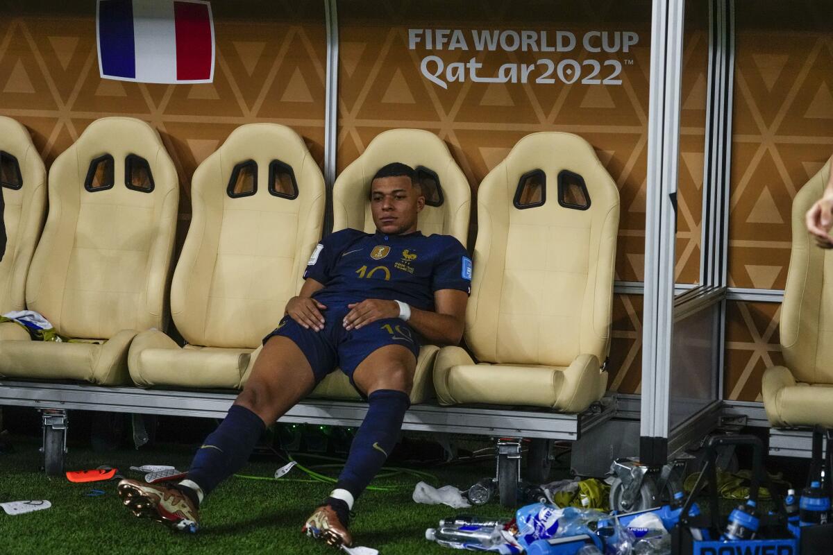 France's Kylian Mbappe sits on the bench following a loss to Argentina in the World Cup final Sunday.