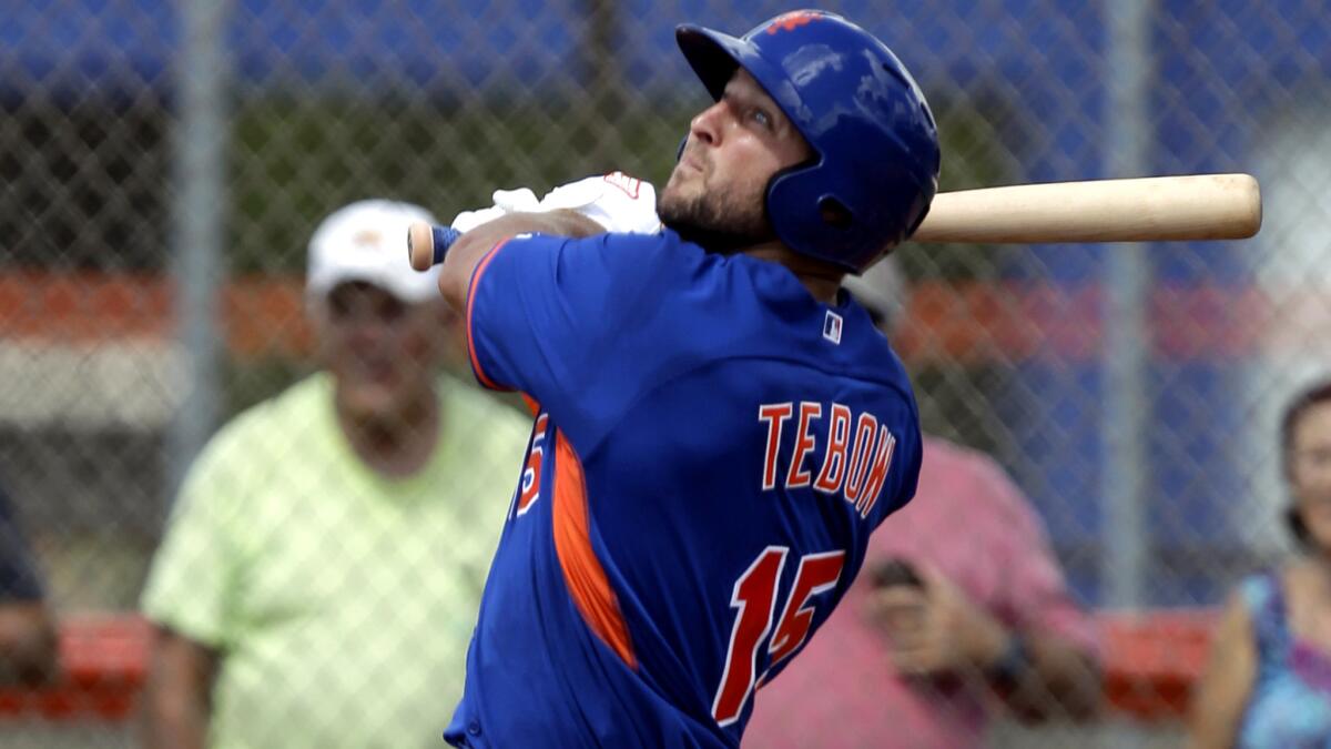 Tim Tebow watches his home run during the first inning of an instructional game on Sept. 28.