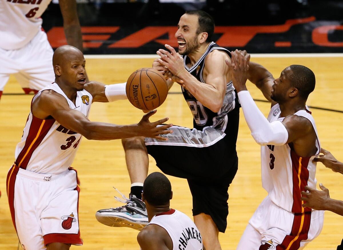 San Antonio Spurs' Manu Ginobili loses the ball between Miami Heat's Ray Allen, left, and Dwyane Wade late in overtime of Game 6.