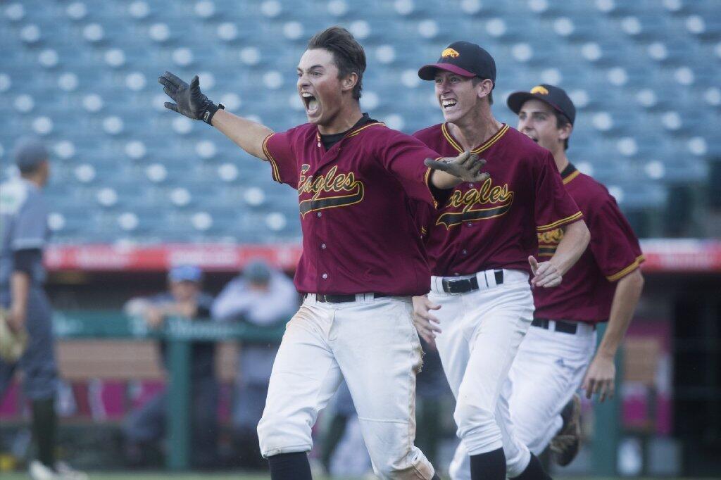 Estancia celebrates after defeating Costa Mesa in the Battle for the Bell finale at Angel Stadium on Monday.