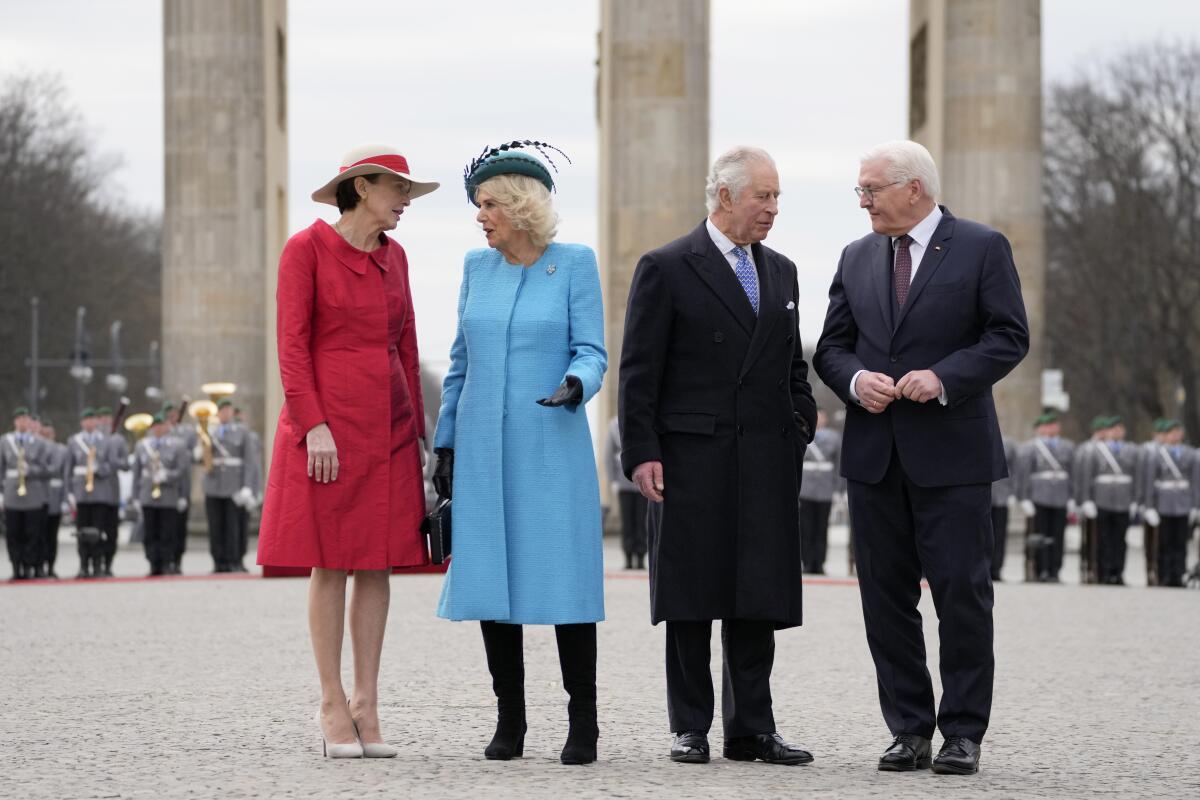 King Charles III and his wife with the German president and his wife in front of the Brandenburg Gate in Berlin