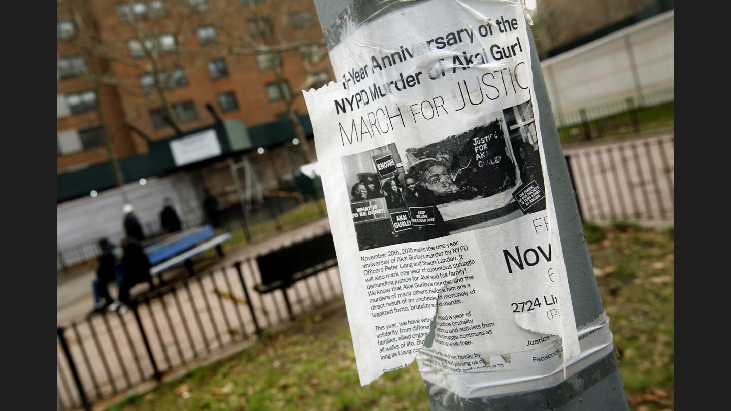 A poster announces a march for justice one year after the shooting death of Akai Gurley, who was unarmed.