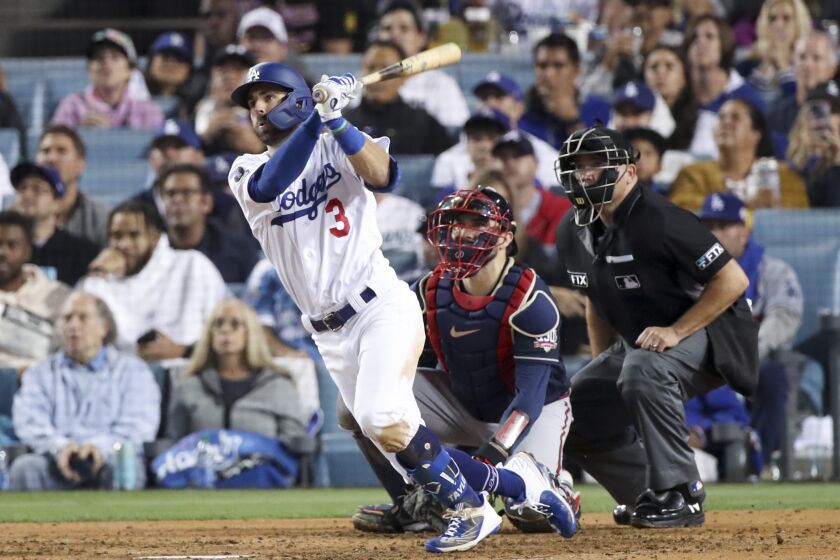 Dodgers' Chris Taylor follows through on a swing for a two-run home run 