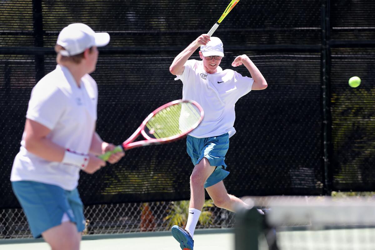Doubles teammates Logan Friedman, right, and Max Krykunenko, left, compete against University in Friday's match.