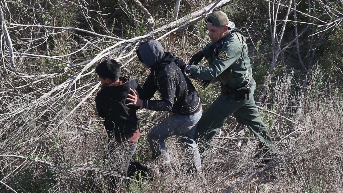 A U.S. Border Patrol agent detains juvenile immigrants in La Grulla, Texas, near the U.S.-Mexico border in 2015.