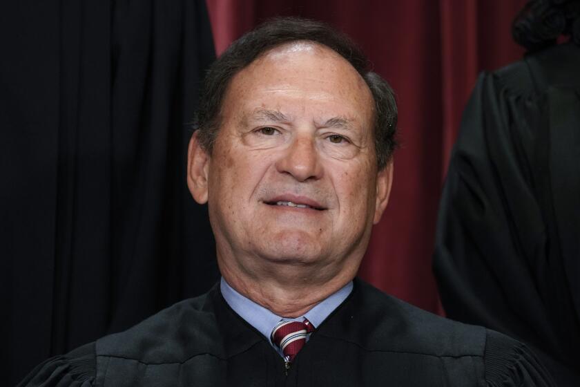 FILE - Associate Justice Samuel Alito joins other members of the Supreme Court as they pose for a new group portrait, at the Supreme Court building in Washington, Oct. 7, 2022. Alito says Congress lacks the power to impose a code of ethics on the Supreme Court, making him the first member of the court to take a public stand against proposals in Congress to toughen ethics rules for justices in response to increased scrutiny of their activities beyond the bench. (AP Photo/J. Scott Applewhite, File)
