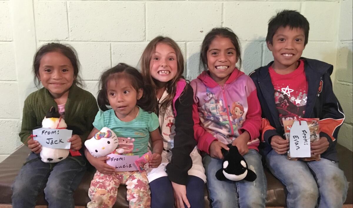 Jessie Ross, center, with locals during her first medical mission trip to Guatemala at age 8.