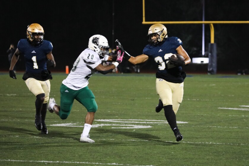 Mater Dei Catholic’s Anthony McMillian eludes a Helix tackler to score on a 66-yard run Friday night.