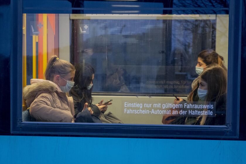 Passengers wear face masks as they sit in a subway in Frankfurt, Germany, Wednesday, Oct. 28, 2020. (AP Photo/Michael Probst)
