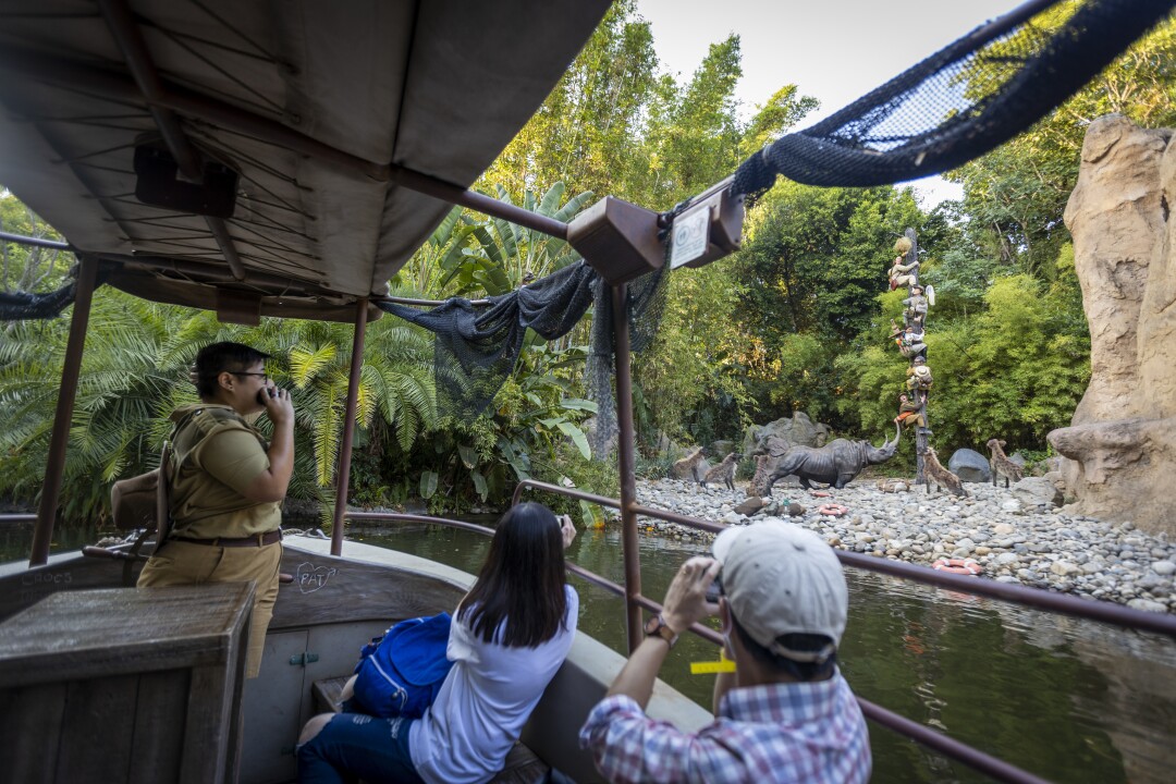 Skipper Amanda Beth Lorenzo leads the Jungle Cruise past animals on shore