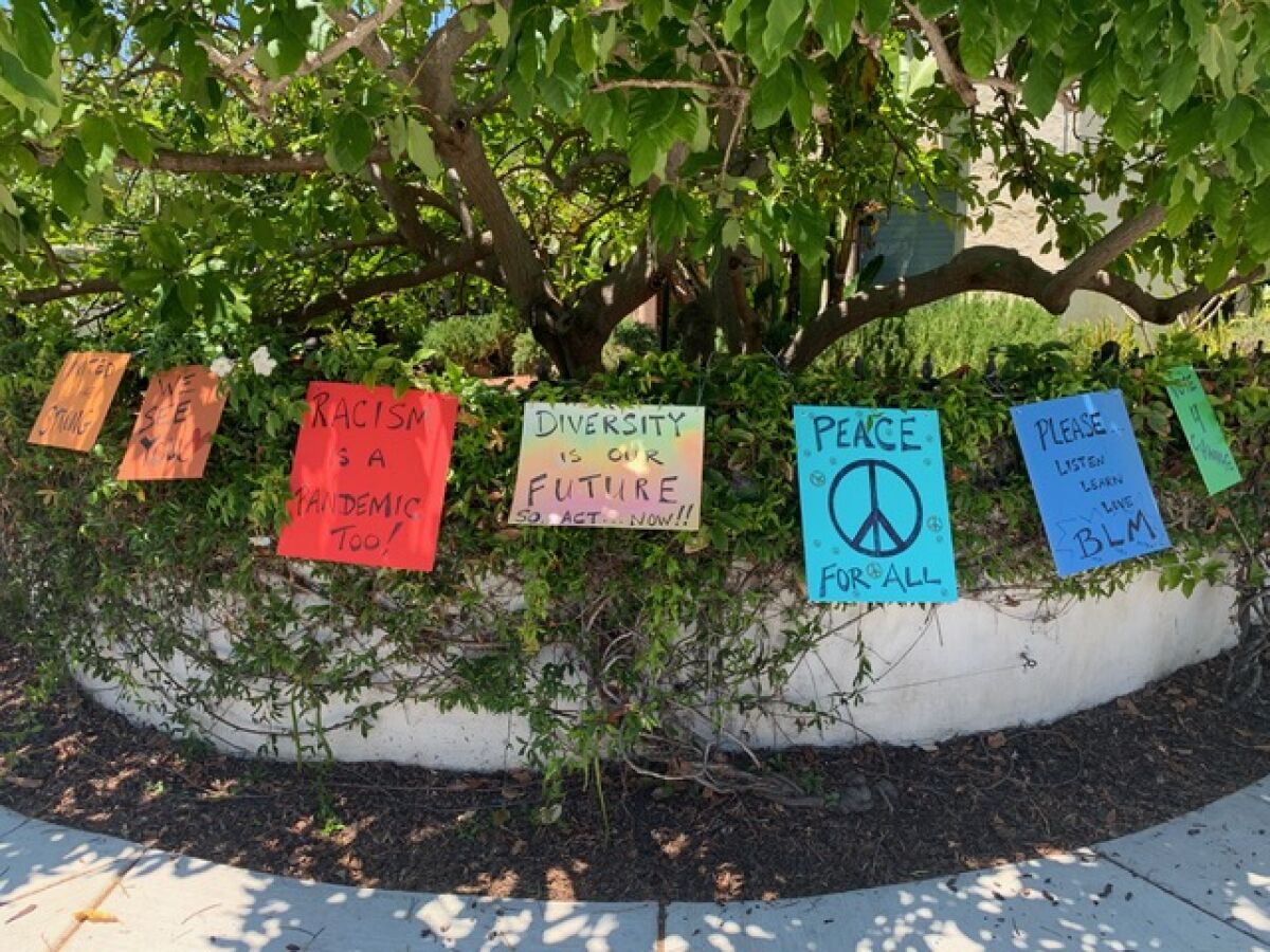 These are signs that Sonia Teder-Moore's daughter placed in front of their home until someone tore them down and took them.
