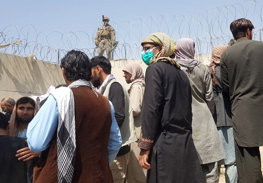 People wanting to flee the country continue to wait around Hamid Karzai International Airport