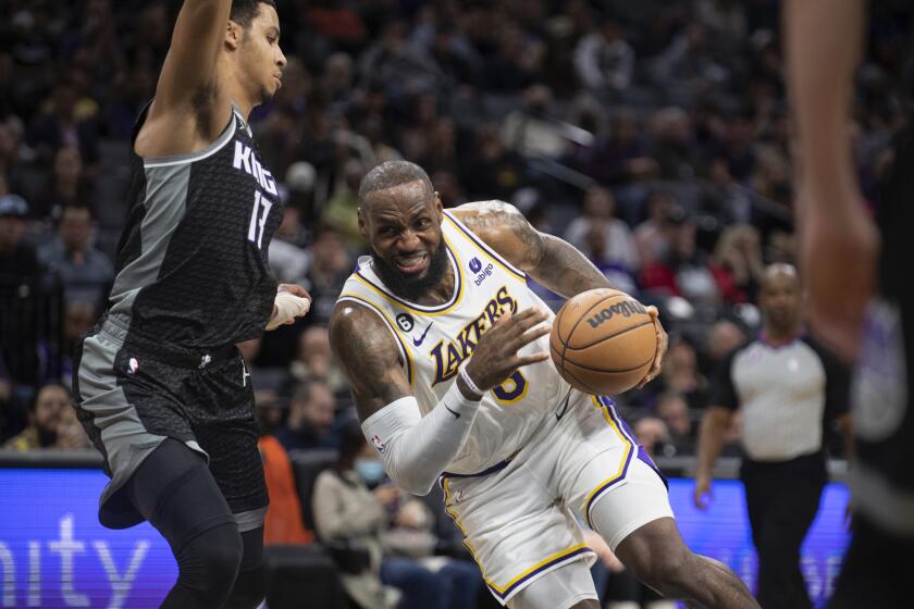 The Lakers' LeBron James drives against the Sacramento Kings' Keegan Murray during the second half Jan. 7, 2023.