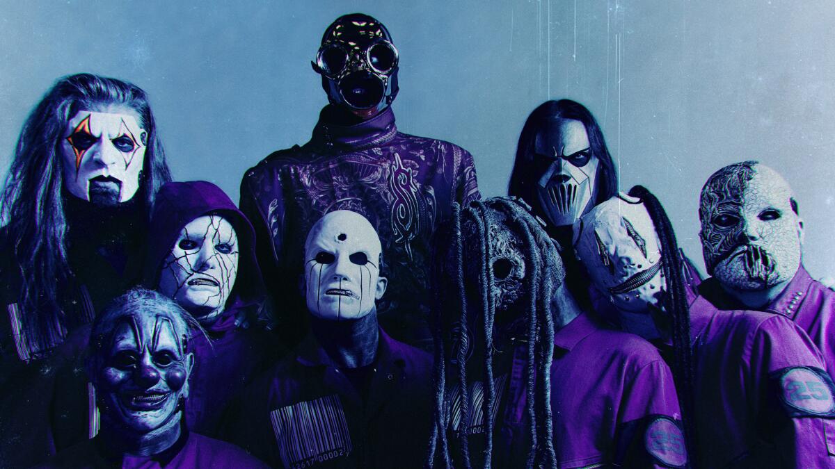 A group of people in scary white facepaint or clown masks and purple robes