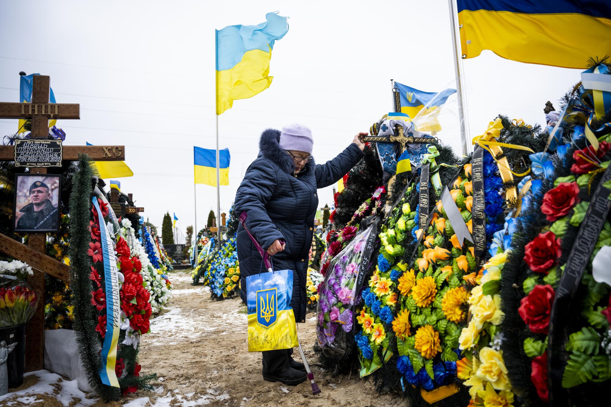 The mother of a Ukrainian soldier killed in Bakhmut grieves at his grave.