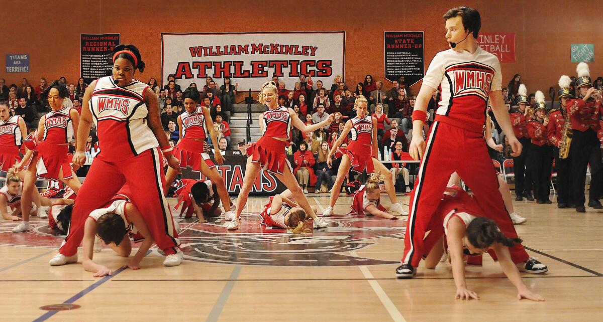 High school cheerleaders performing a routine is a gymnasium